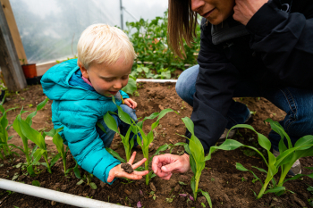 Montana Fleshman Farm USDA NRCS Supervisory District Conservationist Paula Gunderson discusses plants and soil health with future farmer. Fleshman Farm, June 2020, Teton County, Montana.